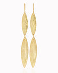 Ajani Earrings by Adele Dejak – handcrafted brass earrings featuring elongated, leaf-shaped pendants with a subtly hammered texture, inspired by African heritage and designed for the modern, sophisticated woman seeking timeless elegance-front view