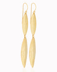 Ajani Earrings by Adele Dejak – handcrafted brass earrings featuring elongated, leaf-shaped pendants with a subtly hammered texture, inspired by African heritage and designed for the modern, sophisticated woman seeking timeless elegance-top wide angle view