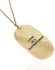 Handcrafted Anita 'Love Is a Superpower' neckpiece by Adele Dejak, featuring a bold, minimalist pendant cast in recycled brass; a statement of empowerment and African-inspired elegance-side view