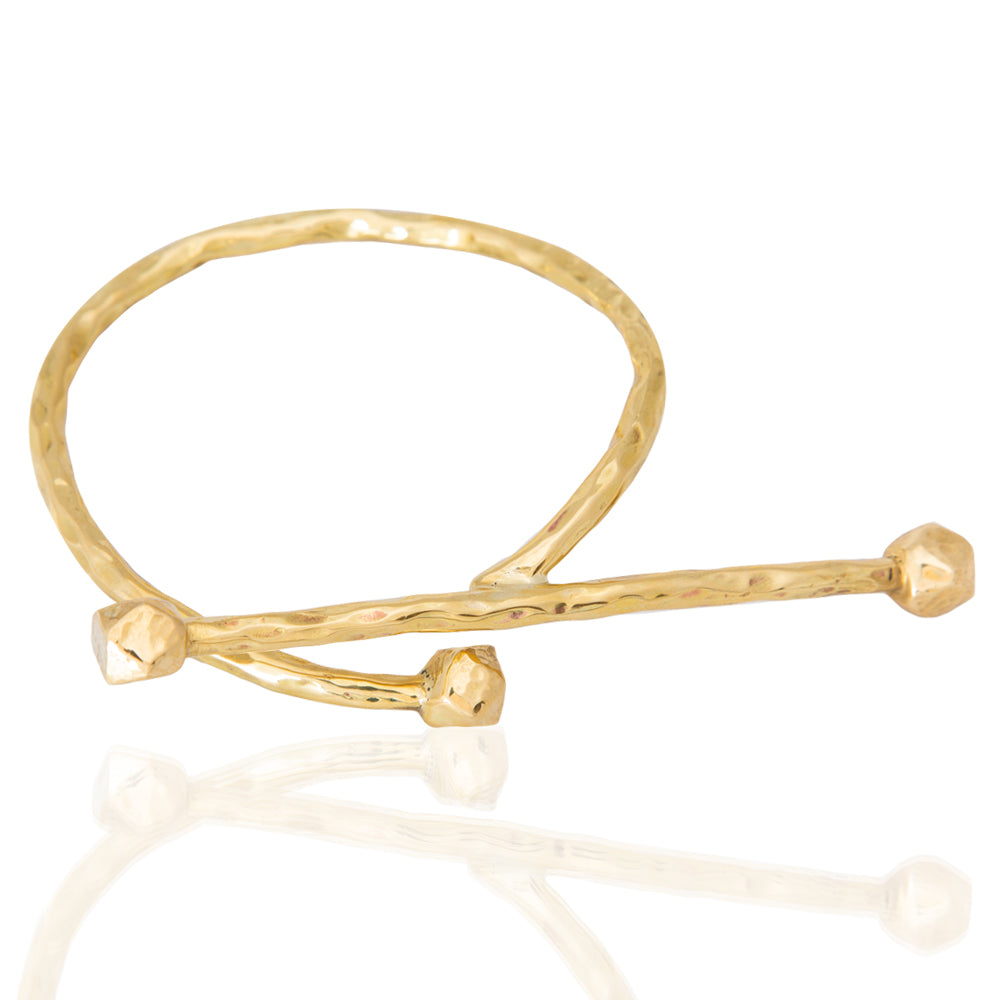 Adele Dejak AVI Bracelet – Handcrafted brass cuff bracelet with a sleek, minimalist design, available in 24K gold-plated and brass finishes. Celebrating African heritage and sustainable craftsmanship, this artisan-made piece offers timeless elegance and versatility, perfect for stacking or solo wear-top view