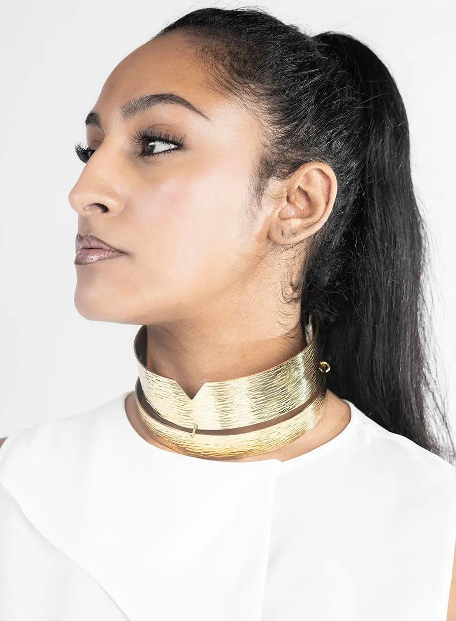Maki Choker: vibrant gold statement necklace, blending artistry and passion for standout style-side view on models neck