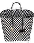 Handwoven black Theresa Bag by Adele Dejak, crafted from recycled plastic with a checkered pattern, featuring dual handles and adorned with signature brass charms, symbolizing sustainable African elegance-wide angle front view