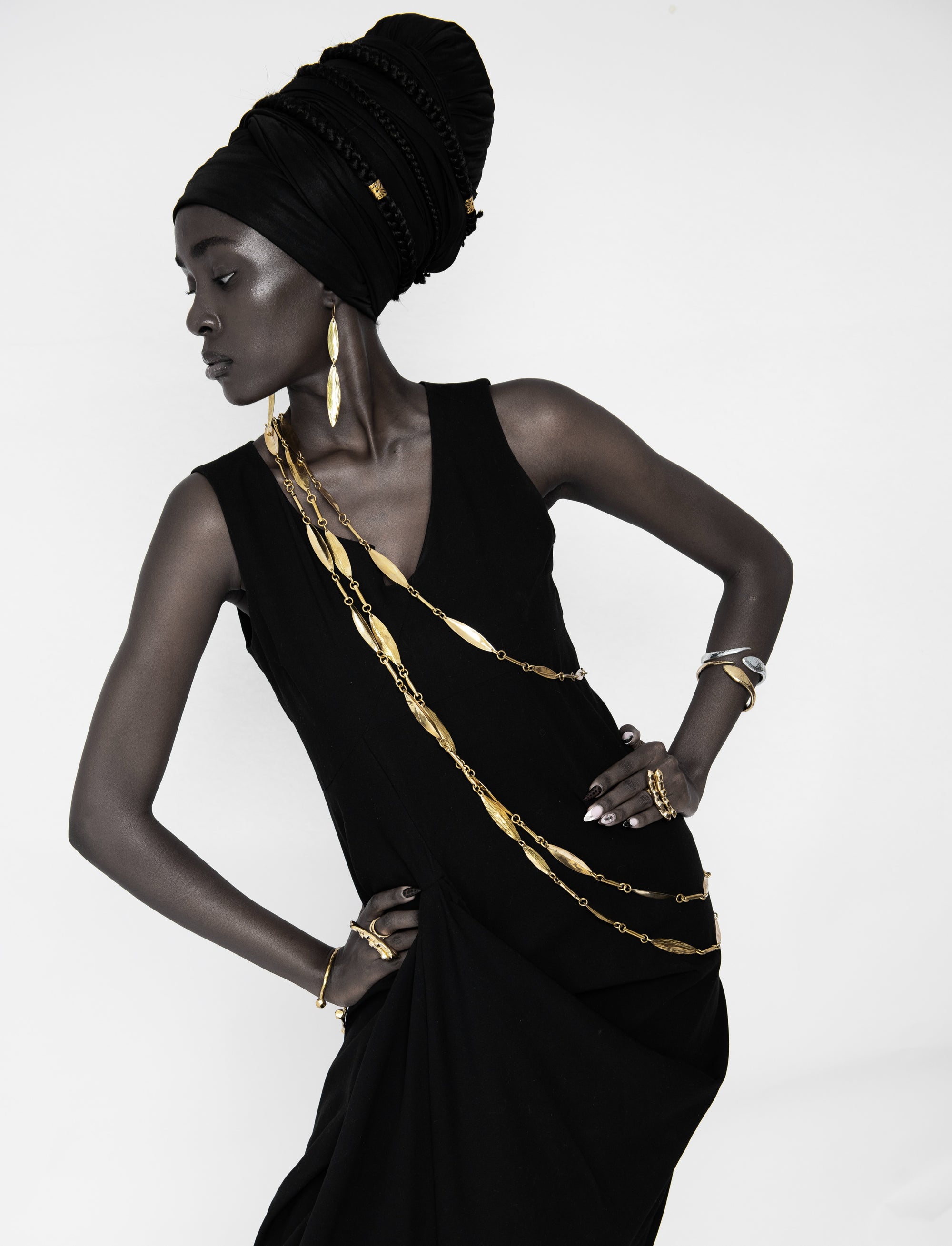 Adele Dejak Aminata Trio Set – a handcrafted trio of gold-tone brass necklaces featuring alternating hammered oval and sleek bar links, available in 88 cm, 127 cm, and 154 cm lengths, offering versatile styling options from bold layering to subtle elegance-model front-view image