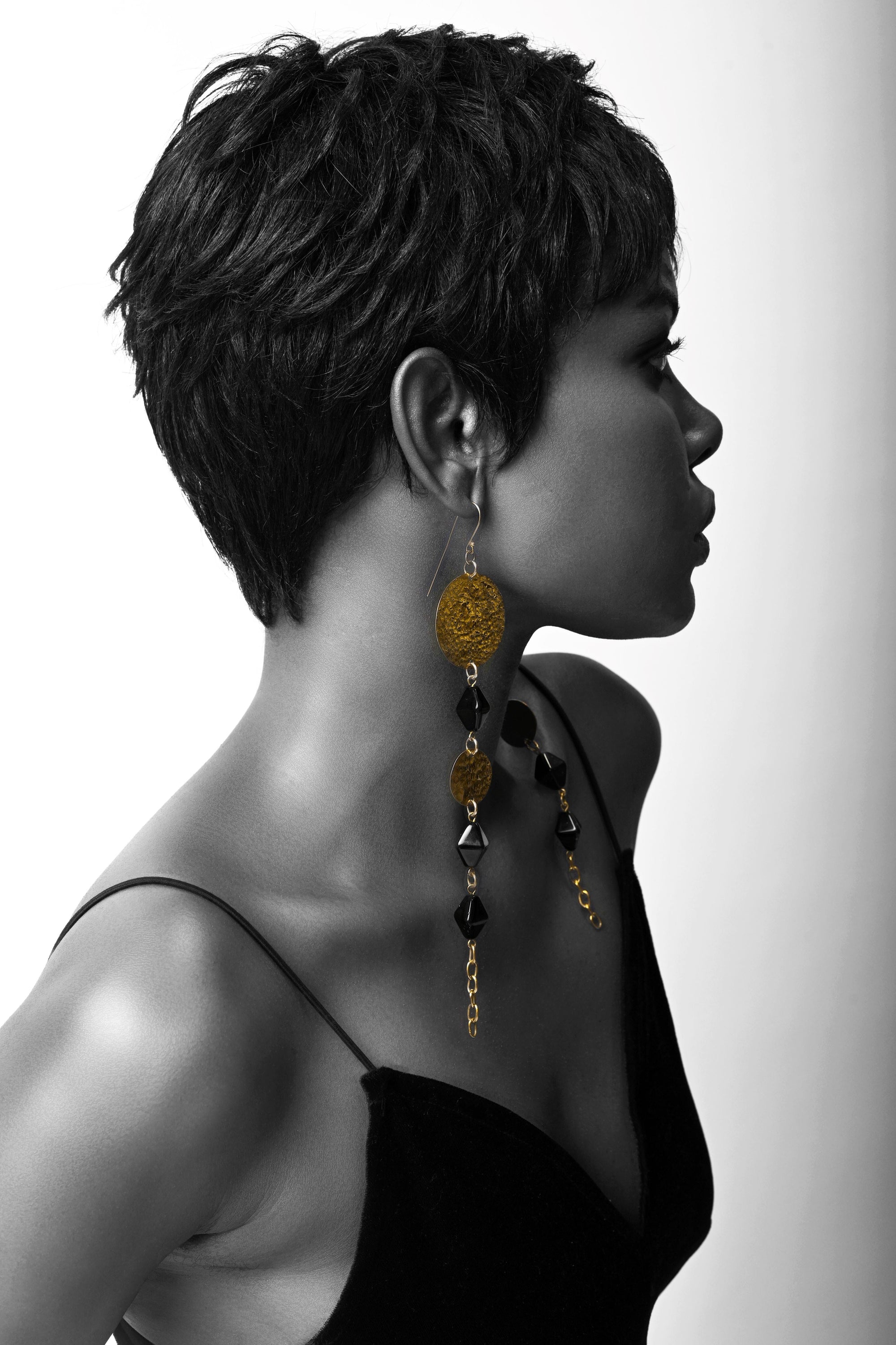 Upcycled brass adele-spice-earrings inspired by African art.